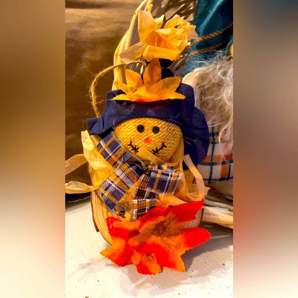 Handmade scarecrow on small round wood